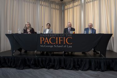 Four individuals speaking on a panel 